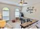 Fun living room area featuring a skeeball machine, overhead lighting, and comfortable seating arrangement at 408 Delwood Breck St, Ruskin, FL 33570