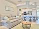 Bright living area showcasing a stone fireplace, comfortable seating, and seamless kitchen integration at 408 Delwood Breck St, Ruskin, FL 33570
