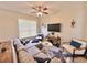 Spacious living room with modern furniture, a ceiling fan, and plenty of natural light at 408 Delwood Breck St, Ruskin, FL 33570
