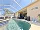 Inviting screened-in pool with connected jacuzzi and outdoor seating area at 408 Delwood Breck St, Ruskin, FL 33570
