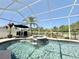 A screened pool area with hot tub and lounge chairs, next to outdoor seating at 408 Delwood Breck St, Ruskin, FL 33570