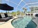 Sparkling pool with a hot tub, lounge chairs and a clear screened lanai overhead at 408 Delwood Breck St, Ruskin, FL 33570
