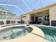 A beautiful screened-in pool, hot tub and patio area is perfect for outdoor entertaining at 408 Delwood Breck St, Ruskin, FL 33570