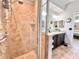 Walk in shower with glass door and beautiful tile, adjacent to the double vanity at 408 Delwood Breck St, Ruskin, FL 33570