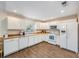 Bright kitchen featuring white cabinetry, wood flooring, and modern appliances at 4116 W Watrous Ave, Tampa, FL 33629