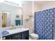Charming bathroom with elegant fixtures, stylish blue vanity, and well-designed storage at 4221 W Spruce St # 2422, Tampa, FL 33607