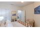 Bedroom featuring stylish furniture, art, and access to an ensuite bathroom at 4221 W Spruce St # 2422, Tampa, FL 33607