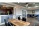 Open dining area with a wooden table and chairs adjacent to a kitchen with modern appliances at 4221 W Spruce St # 2422, Tampa, FL 33607