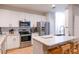 Modern kitchen featuring white cabinets, stainless steel appliances, and a breakfast bar at 4221 W Spruce St # 2422, Tampa, FL 33607