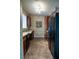 Galley kitchen with dark wood cabinetry, black appliances, and tile flooring at 4221 W Spruce St # 2422, Tampa, FL 33607