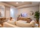 Bright living room featuring hardwood floors, recessed lighting, a modern tv and a comfortable couch at 4221 W Spruce St # 2422, Tampa, FL 33607