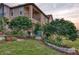 Beautifully landscaped front yard with lush greenery, decorative planters, and a charming statue at 4689 Wandering Way, Wesley Chapel, FL 33544