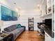 Well-lit office with a daybed, built-in shelving, and hardwood floors for a productive workspace at 4689 Wandering Way, Wesley Chapel, FL 33544