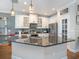 Bright kitchen showcasing a large center island with granite countertops and stainless steel appliances at 4689 Wandering Way, Wesley Chapel, FL 33544