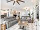 Spacious living room with stylish decor, hardwood floors, and a view of the kitchen at 4689 Wandering Way, Wesley Chapel, FL 33544