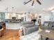 Open living area with hardwood floors, a cozy sofa set, and an adjoining modern kitchen at 4689 Wandering Way, Wesley Chapel, FL 33544