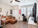 Well-lit, versatile living room with comfortable seating, a functional desk space and closet at 4689 Wandering Way, Wesley Chapel, FL 33544
