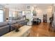 Open living room with hardwood floors that features a view of the kitchen and dining areas at 4689 Wandering Way, Wesley Chapel, FL 33544