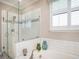 Bright bathroom highlighting a glass-enclosed shower and tub with modern tile and fixtures at 4689 Wandering Way, Wesley Chapel, FL 33544