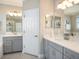 Elegant main bathroom featuring double vanities, and a walk-in shower at 4689 Wandering Way, Wesley Chapel, FL 33544