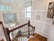 Elegant staircase with wooden treads, decorative metal railing, and plenty of natural light at 4689 Wandering Way, Wesley Chapel, FL 33544