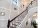 Staircase with wooden treads, decorative metal railing, and stylish wall decor at 4689 Wandering Way, Wesley Chapel, FL 33544