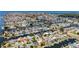 Wide aerial view of a waterfront neighborhood with canals, docks, lush trees, and houses close together at 4920 Pelican Dr, New Port Richey, FL 34652