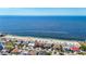 Stunning aerial view showcases beachfront homes with pristine shoreline and sparkling blue ocean waters at 4920 Pelican Dr, New Port Richey, FL 34652