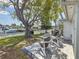 Back patio with outdoor seating, lush lawn, mature trees, and waterfront views creating a peaceful backyard retreat at 4920 Pelican Dr, New Port Richey, FL 34652