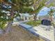 The backyard features a patio with dining, grill, lush lawn and mature trees creating a private outdoor setting at 4920 Pelican Dr, New Port Richey, FL 34652