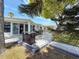 This backyard features a dining set, grill, and a beautiful canopy from the shade tree at 4920 Pelican Dr, New Port Richey, FL 34652