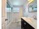 This bathroom offers a tub-shower, decorative window, and charming coastal-themed decorations at 4920 Pelican Dr, New Port Richey, FL 34652