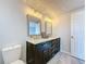 Well-lit bathroom featuring double sink vanity with framed mirrors and modern fixtures at 4920 Pelican Dr, New Port Richey, FL 34652