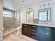 Modern bathroom features a large walk-in shower and a double vanity with marble countertop at 4920 Pelican Dr, New Port Richey, FL 34652