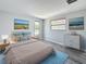 This primary bedroom boasts wood-look flooring, calming wall colors, and a neutral-toned bed at 4920 Pelican Dr, New Port Richey, FL 34652