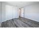 Clean empty bedroom with gray floors, white paint, and a large closet at 4920 Pelican Dr, New Port Richey, FL 34652