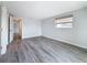 Bare bedroom with wood-look floors and natural lighting has plenty of design potential at 4920 Pelican Dr, New Port Richey, FL 34652