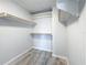 An organized closet featuring built-in shelves, hardware, and wood-look flooring at 4920 Pelican Dr, New Port Richey, FL 34652