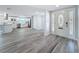 Open-concept layout featuring a foyer, kitchen, and dining area with wood-look floors and modern finishes at 4920 Pelican Dr, New Port Richey, FL 34652