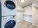 This laundry room features a stacked washer and dryer and built-in storage shelves at 4920 Pelican Dr, New Port Richey, FL 34652