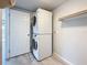 Efficient laundry area with stacked washer/dryer, wood-look flooring, and convenient access at 4920 Pelican Dr, New Port Richey, FL 34652