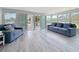 Open living room boasts waterfront views from large windows and sliding doors to the outside at 4920 Pelican Dr, New Port Richey, FL 34652