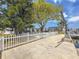 Waterfront home with a well-maintained lawn, mature trees, a dock, and a boat lift enhance the outdoor living space at 4920 Pelican Dr, New Port Richey, FL 34652
