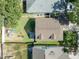Aerial view of the house with a well-maintained lawn, patio, and cozy seating in backyard at 5607 Tanagergrove Way, Lithia, FL 33547