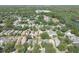 Overhead view of a neighborhood with tree-lined streets and verdant landscapes, highlighting the community's appeal at 5607 Tanagergrove Way, Lithia, FL 33547