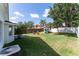 Expansive backyard with lush green grass, a playset, and a cozy fire pit area, ideal for relaxation at 5607 Tanagergrove Way, Lithia, FL 33547