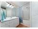 Bright bathroom with a vanity sink, shower-tub combo and white cabinets at 5607 Tanagergrove Way, Lithia, FL 33547