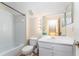 Bathroom featuring tile flooring, a shower-tub combo, a toilet and a vanity with a large mirror at 5607 Tanagergrove Way, Lithia, FL 33547