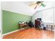 Bedroom with an accent wall, wood-look floors, and vaulted ceilings with a fan at 5607 Tanagergrove Way, Lithia, FL 33547