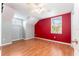 Bedroom with an accent wall, wood-look floors, and vaulted ceilings with a fan and natural lighting at 5607 Tanagergrove Way, Lithia, FL 33547